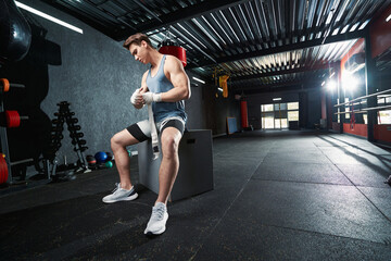 Fototapeta na wymiar Male athlete preparing for boxing training at gym