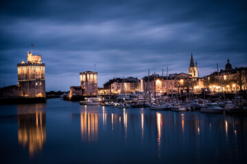 Obraz na płótnie Canvas Panoramic view of the old harbor of La Rochelle at blue hour with its famous old towers