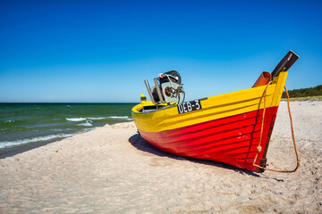 Naklejka na ściany i meble Fishing boat on the sunny Baltic Sea beach in Debki. Poland