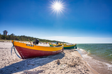 Fishing boat on the sunny Baltic Sea beach in Debki. Poland