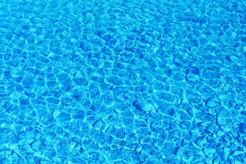 Ripple water abstract background with small pebbles.