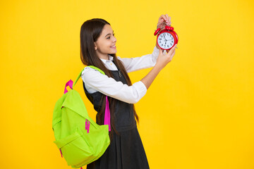 Back to school. Teenager schoolgirl with backpack hold clock alarm, time to learn. School children...