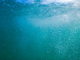 Sea turquoise water with many small bubbles. Underwater photography. Background. Full screen blurry image.
