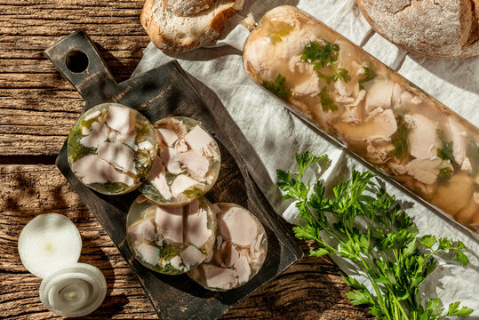 Traditional russian cousine holodets aspic with chicken meat jelly ,fresh vegetables on wooden background, top view