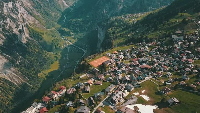 Drone shot of Murren, a traditional Walser mountain village in the Bernese Highlands of Switzerland. Homes and hotels with mountains in the distance