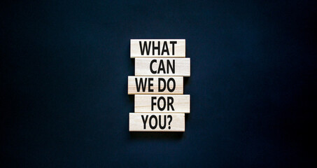 Support symbol. Concept words What can we do for you on wooden blocks on a beautiful black table...