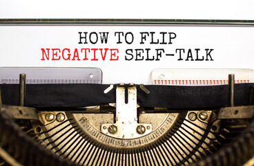 Flip negative self-talk symbol. Concept words How to flip negative self-talk typed on old retro typewriter. Beautiful white background. Psychological and flip negative self-talk concept. Copy space.