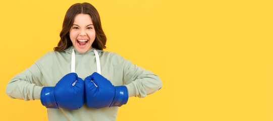 shouting child in boxing gloves on yellow background, sport. Horizontal poster of isolated child...