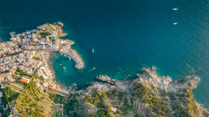 Aerial view of Vernazza and coastline of Cinque Terre,Italy.UNESCO Heritage Site.Picturesque colorful coastal village located on hills.Summer holiday,travel background.Italian Riviera with beaches