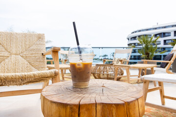 Modern ice latte take away coffee on table, hotel vacation, great design for any purposes. Relaxation concept. Natural aroma drink. Summer background. 