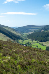 Fototapeta na wymiar Looking down a valley towards a town in Wicklow National Park
