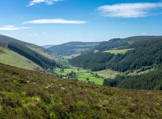 Naklejka premium Looking down a valley towards a town in Wicklow National Park