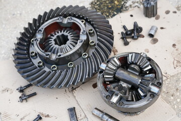 Close up on disassembling differential vehicle part during repair gear axle assembly