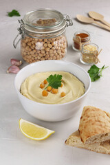 Hummus traditional oriental vegan sauce from chickpea and ingredients. Healthy food. Selective focus