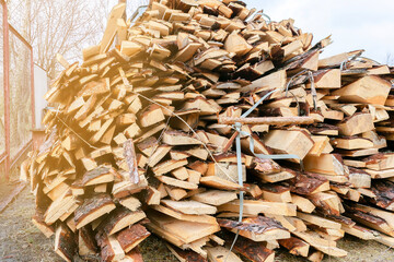 Industrial timber wood for carpentry, building or repairing, lumber material for roofing construction. stack natural chopped dry trunks, Fire logs prepared for winter, ready for burning