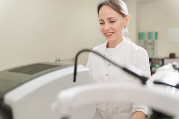 doctor examines eyes on screen of autorefractometer. 