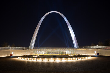 Glowing Gateway Arch National Park of St. Louis with spot lights at night time 