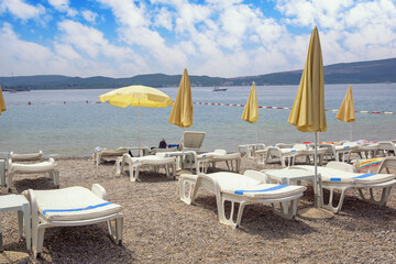 Fototapeta na wymiar Summer beach vacation. Beautiful Mediterranean landscape. Montenegro, Adriatic Sea, view of Bay of Kotor near Tivat city