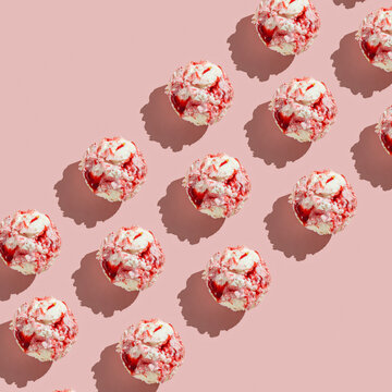 Ice cream balls pattern with copy space on a pastel pink background. Summertime, dessert minimal concept. Top view. Strawberry gelato, hard light