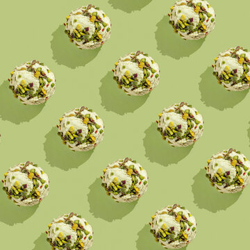 Ice cream balls pattern with copy space on a pastel green background. Summertime, dessert minimal concept. Top view. Pistachio, hard light