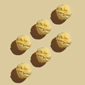 Ice cream balls pattern with copy space on a pastel beige background. Summertime, dessert minimal concept. Top view. Tiramisu vanilla , hard light
