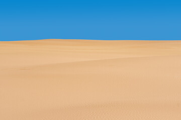 Fototapeta na wymiar lifeless sandy desert landscape under blue sky
