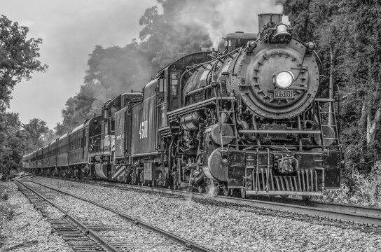 Classic steam locomotive rushing down track in vintage black and white in Chuckey, TN
