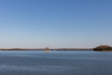 Fototapeta na wymiar Luau Island at Percy Priest Lake and boat in background, Nashville, TN
