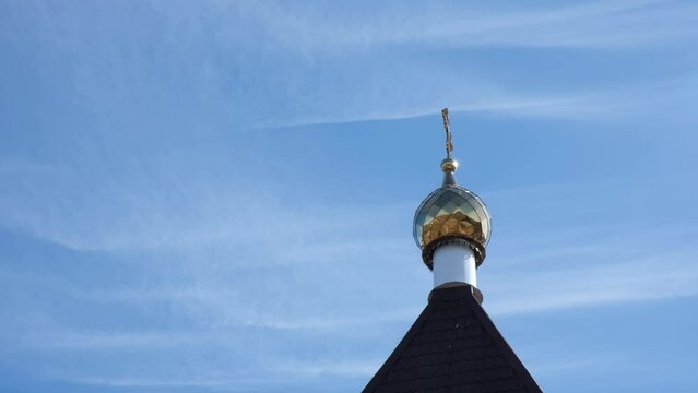 blue sky and temple domes Religion and spirituality concept image. Rays from sun beam down on cross.