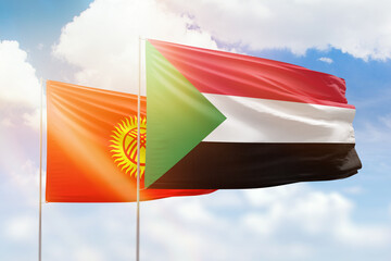 Sunny blue sky and flags of sudan and kyrgyzstan