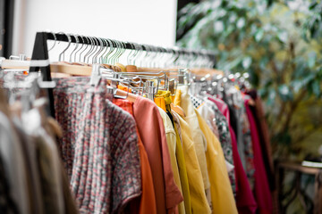Clothing on hanger at the modern shop boutique. 
clothes on hangers in store. Modern dressing room interior with rack of stylish shoes and women's clothes. Fashionable clothes on hangers on a wardrobe