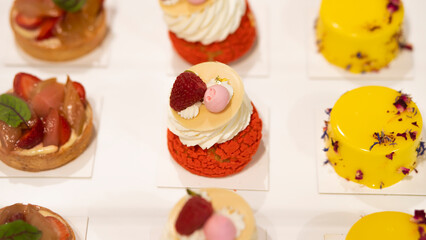 cake with strawberry and raspberry flavor poured over with red velvet and decorated with fruits and chocolate, as well as fruit soufflé. Photography for restaurants and cafes. Advertising cafe with ca