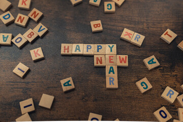 Happy New Year. Party idea for everyone. Wooden letter puzzle game as a way of spending time without social media. High quality photo