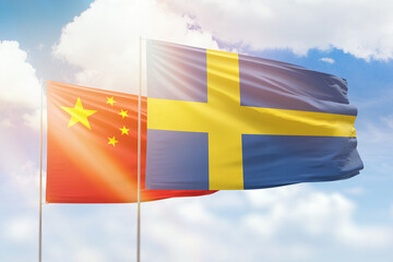 Sunny blue sky and flags of sweden and china