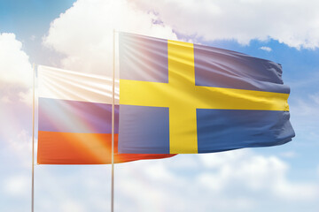 Sunny blue sky and flags of sweden and russia