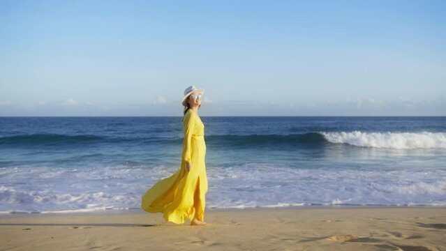 Happy female traveler adores summer vacation on Hawaii island RED camera. Slow motion elegant lady happily walking by tropical island on sunny summer sunset. Woman enjoying scenic ocean beach views 6K