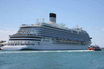 Fototapeta na wymiar Modern cruise ship and boat in sea on sunny day