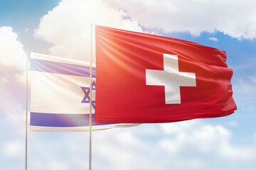 Sunny blue sky and flags of switzerland and israel