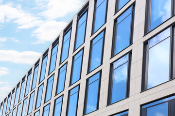 Fototapeta na wymiar Modern building against blue sky, low angle view