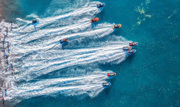 Aquabike championship on Jarun lake, Zagreb Croatia. Aerial view of the speed watercrafts in clear blue water at sunset in summer. Top view from drone of fast motorboats. Race. Water scooter