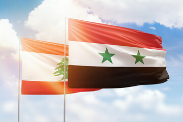 Sunny blue sky and flags of syria and lebanon