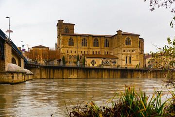 View of Roman Gothique building of ancient Collegiate church Saint Barnard on bank of Isere river i - obrazy, fototapety, plakaty