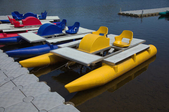 pedalo boats accosted on quay in water summer sport recreation