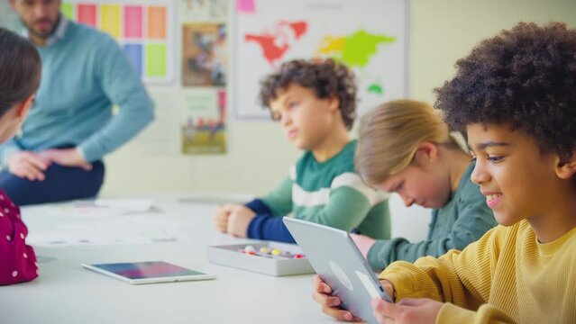 Multi-cultural students with teachers in classroom studying molecular model in science class using digital tablets - shot in slow motion