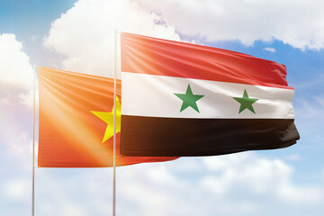 Sunny blue sky and flags of syria and vietnam