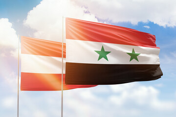 Sunny blue sky and flags of syria and austria