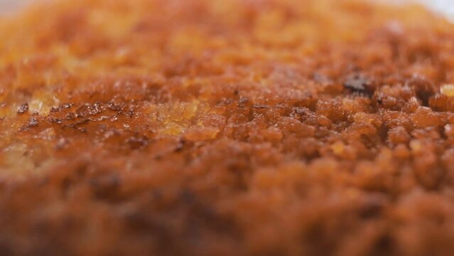 Close-up of the golden surface of a chicken cutlet