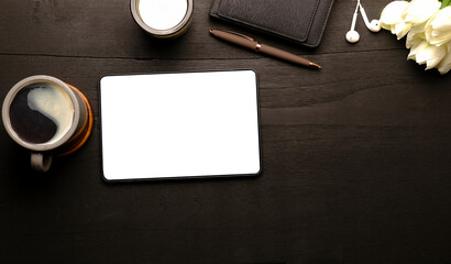 Top view office desk with digital tablet, coffee cup and notebook.