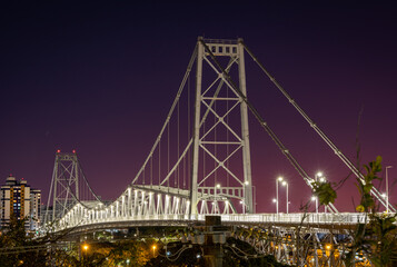 Night view of the Hercilio Luz suspension bridge. The longest suspension bridge in Brazil and the symbol of the city of Florianopolis. Design engineering structure bridge at night. Illumination of the