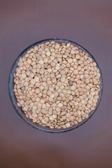 taz&oacute;n de semillas de lentejas con foto cenital en un fondo caf&eacute; 